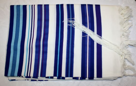 Before putting on a tallit, it is a customary tradition to kiss it and 