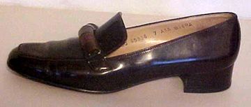   sole has wooden bead adornments on top of shoes in a loafer style